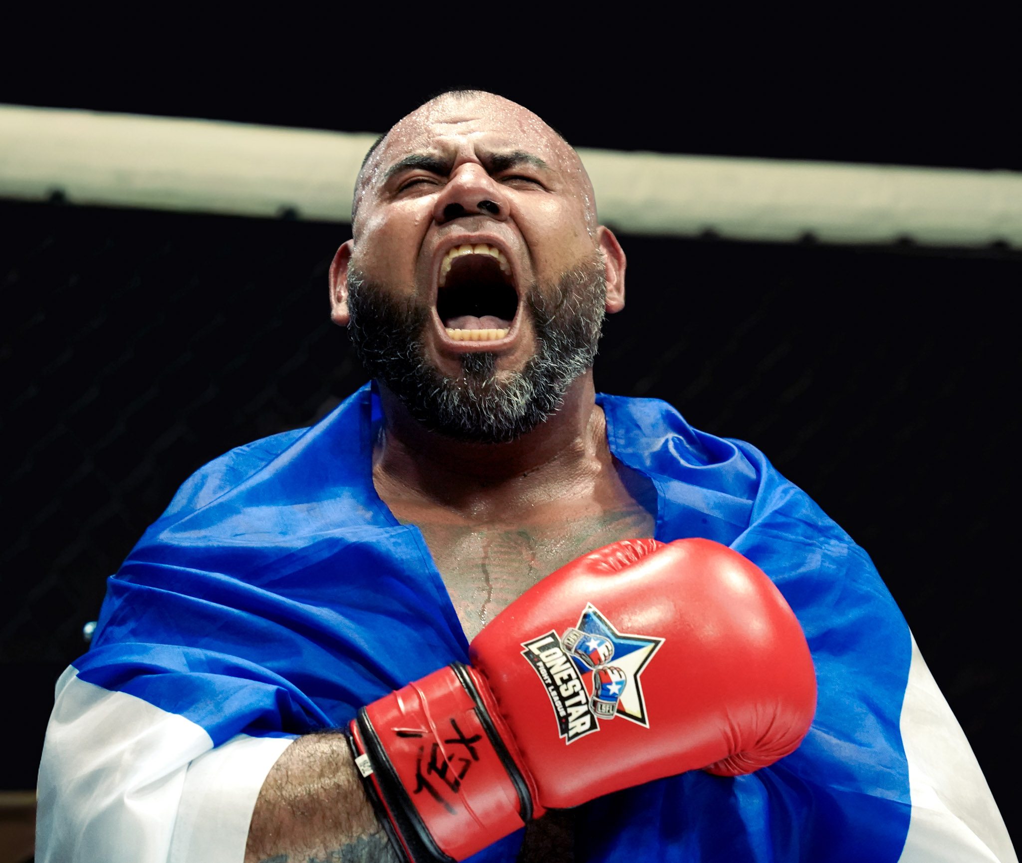 Fernando Medrano roars with flag and LSFL gloves