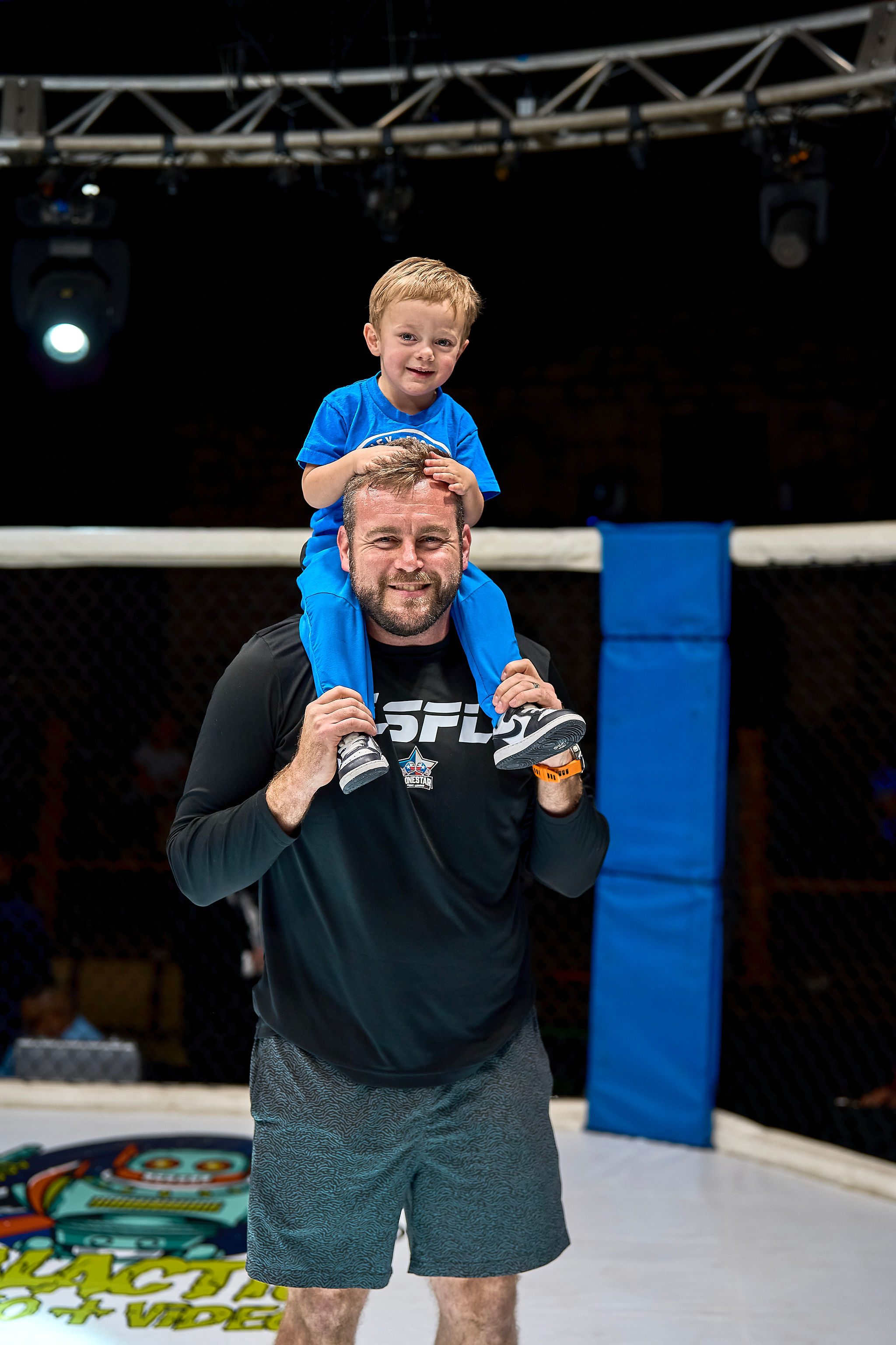 Parker Keane with son on shoulders in the ring